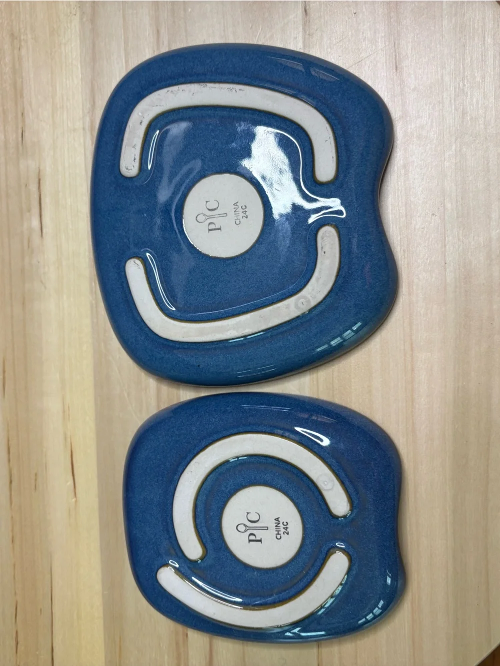 Pampered Chef Nesting Spoon Rest Set featuring a blue glaze with a swirl design.
